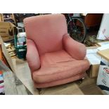 PINK UPHOLSTERED BEDROOM ARMCHAIR ON MAHOGANY FOOT SUPPORTS WITH BRASS CASTERS