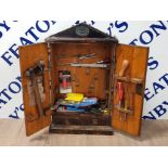 ANTIQUE ARMY AND NAVY TOOL CABINET WITH CONTENT SUCH AS HAMMERS SCREWDRIVERS ETC