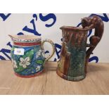 A HAND PAINTED STUDIO POTTERY JUG SIGNED EGJ TOGETHER WITH ANOTHER WITH CAT PATTERN HANDLE