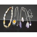A PENDANT BY A GORSKI A HARDSTONE NECKLACE AND FOUR AMETHYST ROCK PENDANTS THREE WITH CHAINS