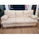 A CREAM LEATHERETTE SUITE COMPRISING A THREE SEATER AND TWO SEATER SOFAS