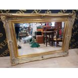 A LARGE BEVELLED WALL MIRROR IN GOLD COLOURED FRAME 88.5 X 116CM