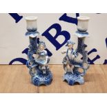 A PAIR OF SITZENDORF STYLE BLUE AND WHITE CANDLESTICKS