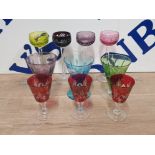 A LOT OF COLOURED GLASS WARE TO INCLUDE A SET OF 4 BOHEMIAN TALL STEM GLASSES