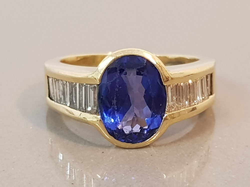 18CT GOLD BLUE OVAL STONE AND BAGUETTE DIAMOND RING 10.2G SIZE P1/2