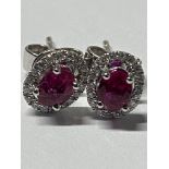 WHITE GOLD RUBY AND DIAMOND CLUSTER EARRINGS RUBY APX .70CT AND DIAMOND APX .16CT