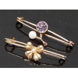 TWO ANTIQUE YELLOW METAL BROOCHES ONE WITH PURPLE STONE AND PEARL THE OTHER FOUR LEAF CLOVER 2.4G