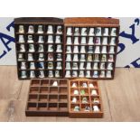 4 WOODEN THIMBLE RACKS CONTAINING A LARGE QUANTITY OF THIMBLES