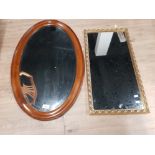 AN EARLY 20TH CENTURY MAHOGANY OVAL BEVELLED WALL MIRROR 77CM HIGH TOGETHER WITH A MODERN ONE IN