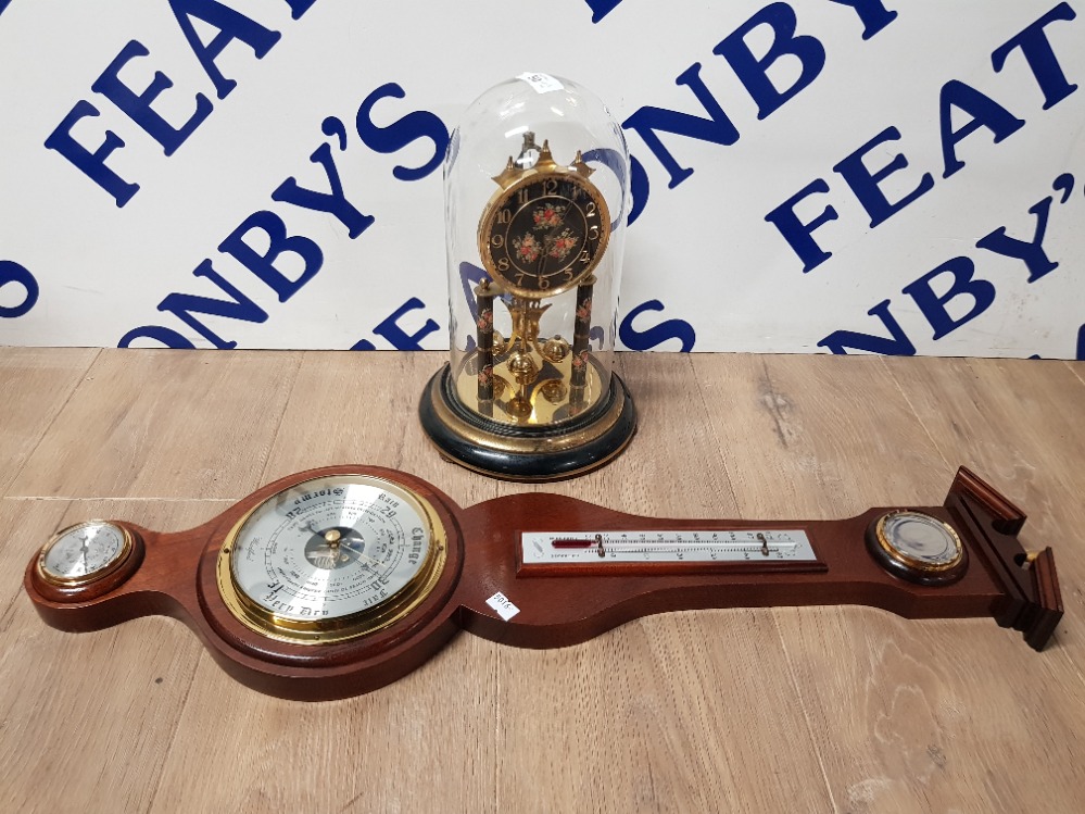 A DOME CLOCK TOGETHER WITH A REPRODUCTION BAROMETER WITH BRASS DIAL