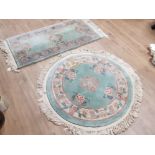 2 GREEN FLORAL PATTERNED CHINESE RUGS, ONE CIRCULAR AND ONE RECTANGULAR BOTH FRINGED