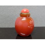 A RED HARDSTONE CHINESE STYLE SNUFF BOTTLE THE STOPPER POTENTIALLY ASSOCIATED 8.5CM HIGH