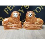 A PAIR OF STAFFORDSHIRE STYLE LION ORNAMENTS 15CM BY 28CM