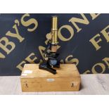 VINTAGE WOODEN BOX CONTAINING A BRASS AND METAL MICROSCOPE, LABELLED A.FRANKS LTD. OPTICIANS