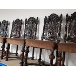 A SET OF 6 HEAVILY CARVED VICTORIAN STYLE DINING CHAIRS WITH X FRAME STRETCHES