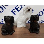 A PAIR OF STAFFORDSHIRE FIRESIDE DOGS TOGETHER WITH ANOTHER
