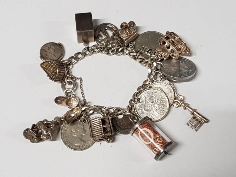 HALLMARKED SILVER CHARM BRACELET WITH 23 CHARMS INCLUDING SILVER 3 PENCES AND EMERGENCY 1 POUND