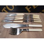 A SET OF STAINLESS STEEL AND IVOREX FISH KNIVES FORK AND SERVERS BY WALKER AND HALL