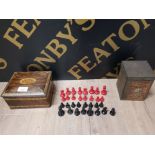 A RED AND BLACK PAINTED METAL CHESS SET TOGETHER WITH TWO VINTAGE TINS