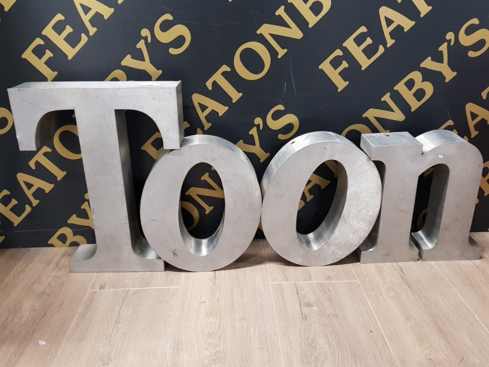 FOUR INDIVIDUAL HAND CRAFTED METAL LETTERS SPELLING THE WORD TOON