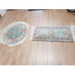 TWO GREEN FLORAL PATTERNED CHINESE RUGS ONE CIRCULAR 100CM DIAMETER AND ONE RECTANGULAR 128 X 61CM