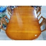 A YEW WOOD TWIN PEDESTAL DINING TABLE AND FOUR MATCHING SHIELD BACK CHAIRS