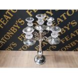 A SILVER COLOURED FOUR BRANCH CANDELABRA WITH FIVE GLASS DRIP TRAYS 68CM HIGH