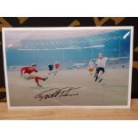 SIGNED 1966 WORLD CUP FINAL 12X8 COLOUR PICTURE SHOWS ACTION SHOT OF GEOFF SHOOTING FOR ONE OF HIS