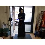 A LARGE FIGURE OF THE GRIM REAPER WITH BATTERY OPERATED VOICE ACTIVATED SENSOR