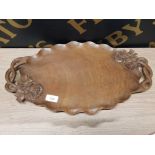 A CARVED WOODEN TWO HANDLED TRAY WITH FLORAL DECORATIONS