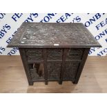 AN EARLY 20TH CENTURY HEAVILY CARVED WOOD FOLDING OCCASSIONAL TABLE 75 X 64 X 52.5CM