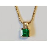 AN 18CT YELLOW GOLD DIAMOND AND OCTAGON STEP CUT COLUMBIAN EMERALD PENDANT THE EMERALD BEING NATURAL