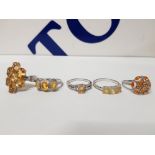 FIVE SILVER RINGS OF VARIOUS DESIGNS WITH ORANGE STONES ALL STAMPED 925 SIZES P TO T+ 22G GROSS