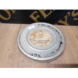 A FILM REEL OF MOTORCYCLING CROSS COUNTRY IN ALLOY CASE