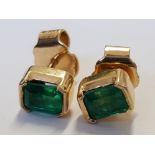 A PAIR OF 18CT YELLOW GOLD AND OCTAGON STEP CUT COLUMBIAN EMERALD STUD EARRINGS THE EMERALDS BEING