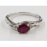 9CT WHITE GOLD OVAL RUBY STONE RING WITH TWO SMALL DIAMONDS, 2.5G GROSS SIZE N1/2