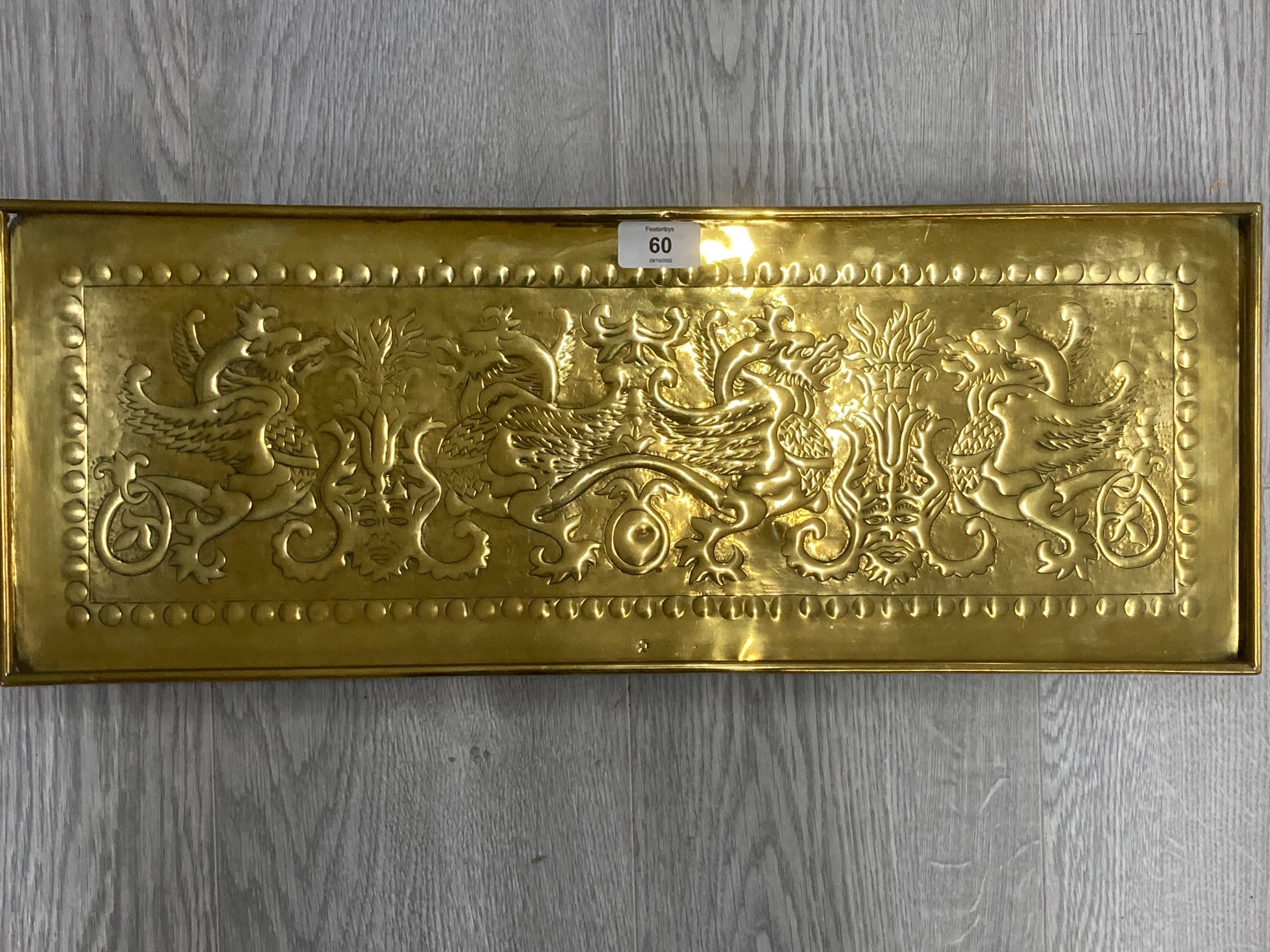 AN ARTS AND CRAFTS RECTANGULAR BRASS TRAY BY KESWICK SCHOOL OF INDUSTRIAL ARTS WITH HERALDIC BEAST