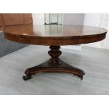 A VICTORIAN ROSEWOOD TIP UP TOP BREAKFAST TABLE RAISED ON TURNED AND CARVED TRIPOD BASE 137.3CM