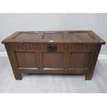 AN ANTIQUE OAK COFFER WITH LATER CARVED PANEL 120.5 X 63 X 49CM
