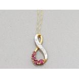 A 9CT YELLOW GOLD RUBY AND DIAMOND PENDANT BY ERNEST JONES ON 9CT GOLD CHAIN 1.3G GROSS