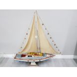 A WOODEN MODEL OF A YACHT ON STAND 122CM HIGH