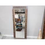 A MODERN WALL MIRROR WITH SILVER COLOURED SCROLLING FRAME 158 X 63CM