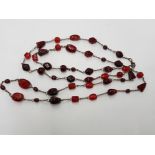 A RED AMBER TYPE BEAD NECKLACE 60CM LONG