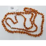 AN AMBER NECKLACE WITH 9K GOLD CLASP 59.5CM LONG 32.2G GROSS