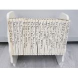 A FULL SET OF BEATRIX POTTER BOOKS ON DEDICATED BOOK TROUGH
