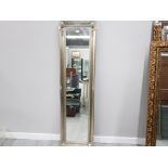 A MODERN SILVER WALL MIRROR WITH SILVER SWEPT FRAME 167 X 44CM