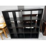 A LARGE LAMINATE STORAGE UNIT WITH 16 COMPARTMENTS 149.5 X 149 X 39CM