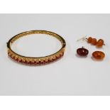 THREE AMBER EARRINGS AND ONE GOOD QUALITY GOLD COLOURED AND RED STONE BANGLE