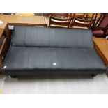 A BLACK LEATHERETTE DAY BED RAISED ON SQUARE TAPERING LEGS NEEDS ATTENTION