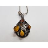 A SILVER AND AMBER PENDANT ON A SILVER CHAIN 18.0G GROSS